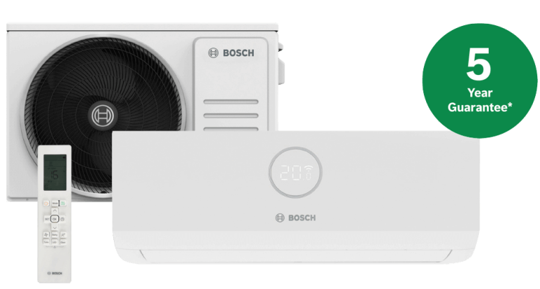 An image showing an AC unit with remote and sticker that advertises a 5 year guarantee